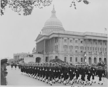 Photograph of troops marching by the U.S. Capitol during ceremonies honoring Admiral Chester Nimitz. - NARA - 199205