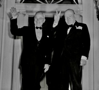 Photograph of Winston Churchill flashing his V for Victory sign and President Truman waving outside Blair House in... - NARA - 200108 (cropped2) photo