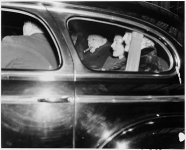 Photograph of Winston Churchill in the back of a limousine with members of his family, evidently soon after his... - NARA - 199352 photo