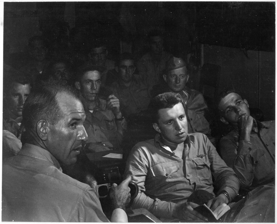 Pilots being briefed on board USS ESSEX the night before they were to raid Formosa. - NARA - 520855