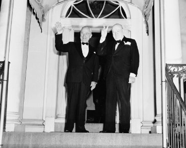 Photograph of Winston Churchill flashing his V for Victory sign and President Truman waving outside Blair House in... - NARA - 200108 (cropped1) photo
