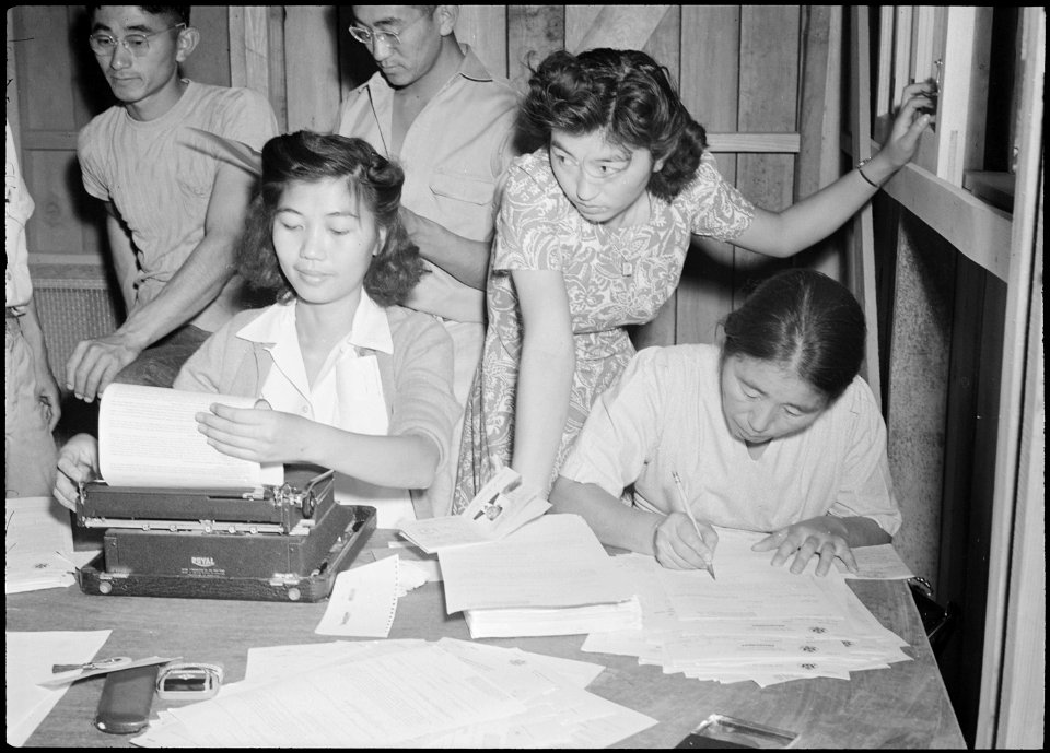 Poston, Arizona. Alice Maeda signs up the Shiomichi family at the Intake center for the War Relocat . . . - NARA - 536328