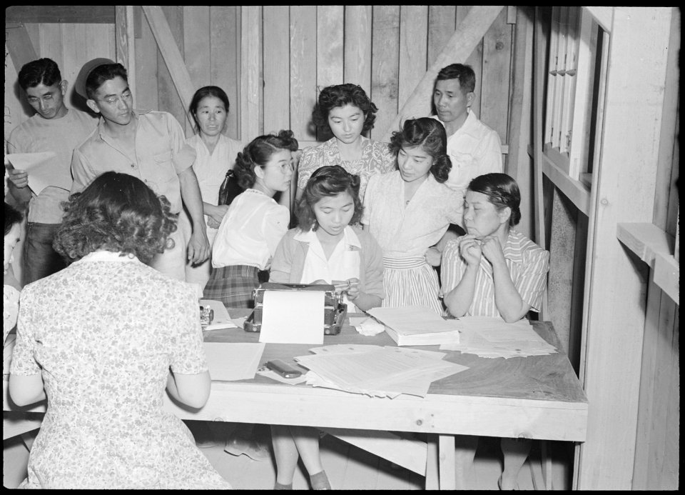 Poston, Arizona. Alice Maeda signing volunteers for War Relocation Authority Work Corps. - NARA - 536330