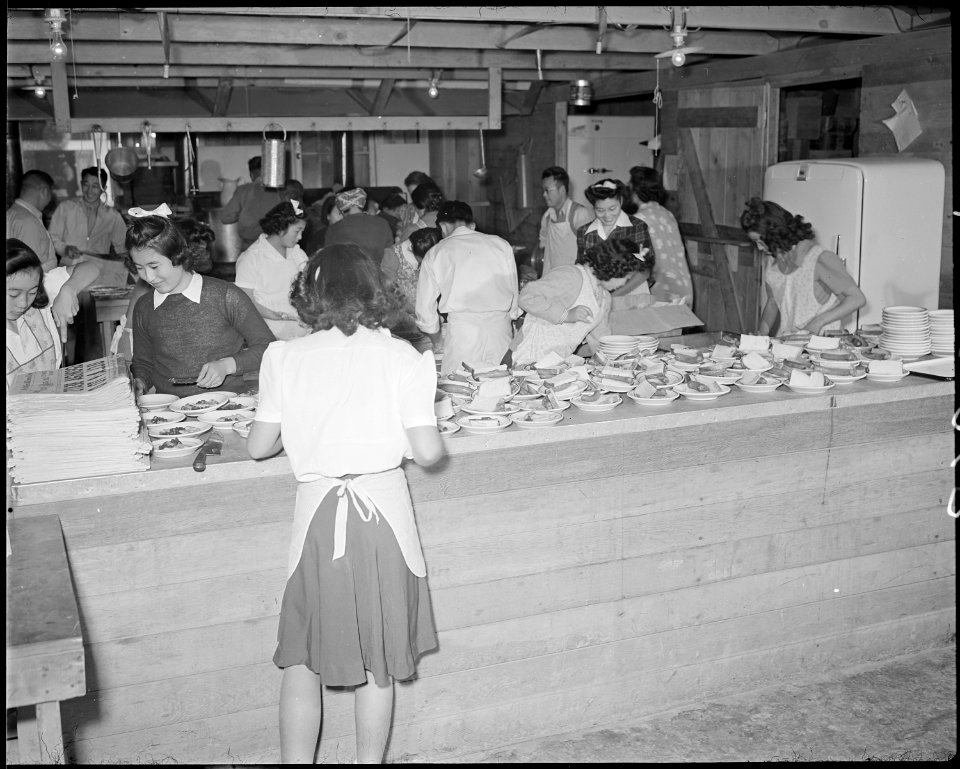 Poston, Arizona. Charcoal making. Evacuee workers warm themselves by fires made from this charcoal . . . - NARA - 536671