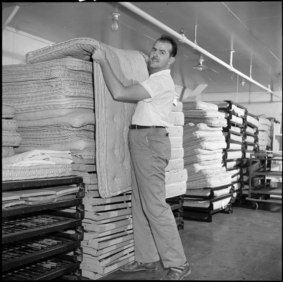 Poston, Arizona. Bedding and mattresses are moved out of Ward Three in the Poston General Hospital . . . - NARA - 539868