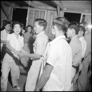 Poston, Arizona. Evacuees of Japanese ancestry dance the Virginia Reel at a barn dance given by blo . . . - NARA - 538578