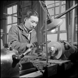Poston, Arizona. George Makanishi, evacuee from Anaheim, California, is shown at work on an engine . . . - NARA - 537120