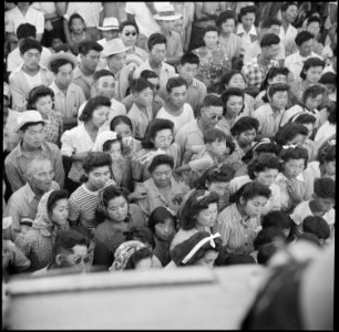 Poston, Arizona. Evacuees of Japanese ancestry watching an outdoor musical performance at this War . . . - NARA - 538561