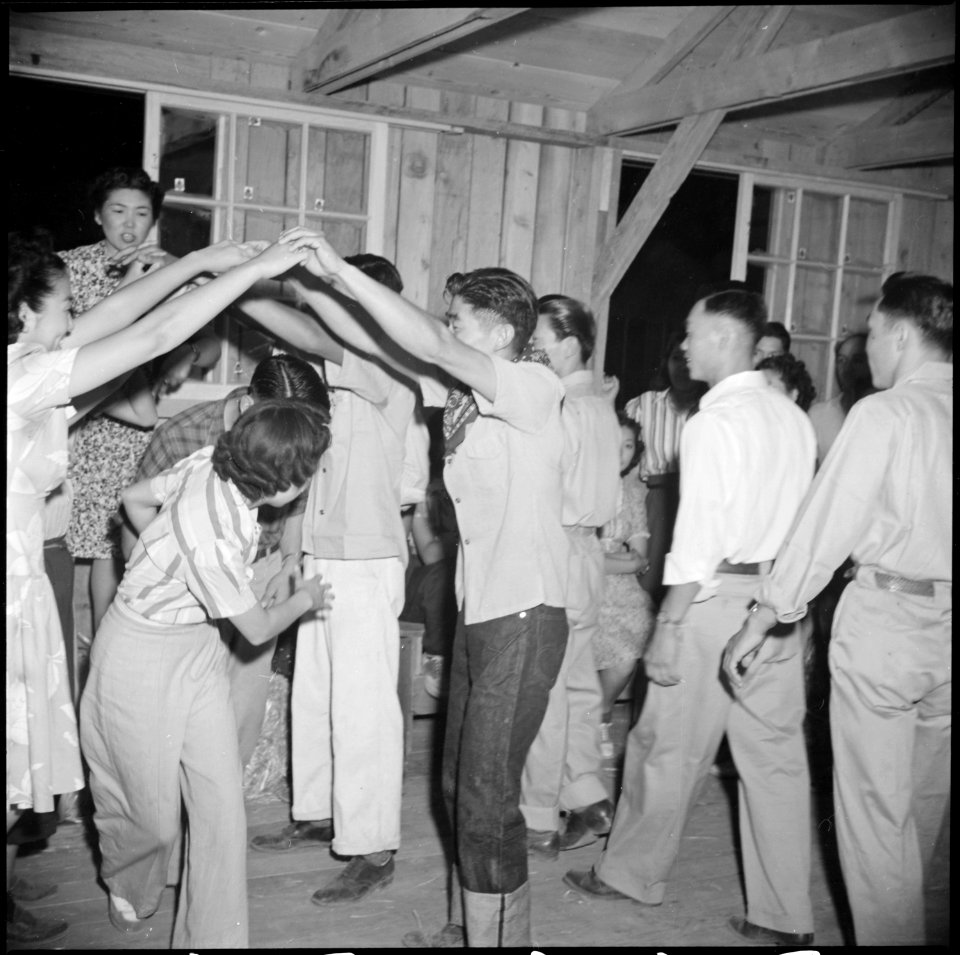 Poston, Arizona. Evacuees of Japanese ancestry dance the Virginia Reel at a barn dance given by Blo . . . - NARA - 538579