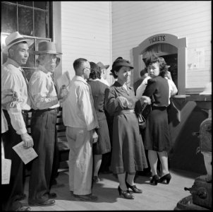 Poston, Arizona. In the warm station, everyone stands in line again to claim his train ticket. Aft . . . - NARA - 539873