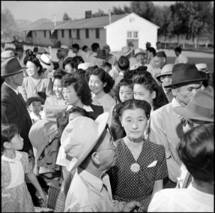 Poston, Arizona. Evacuees stand in line before the departure station where they are to receive thei . . . - NARA - 539870 photo