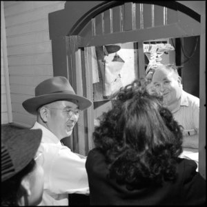 Poston, Arizona. In the warm station, everone stands in line again to claim his train ticket. Afte . . . - NARA - 539874