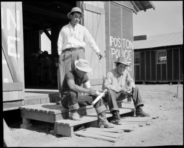 Poston, Arizona. Members of the police department carving clubs at this War Relocation Authority ce . . . - NARA - 536097