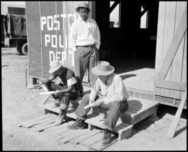 Poston, Arizona. Members of the police department carving clubs at this War Relocation Authority ce . . . - NARA - 536101