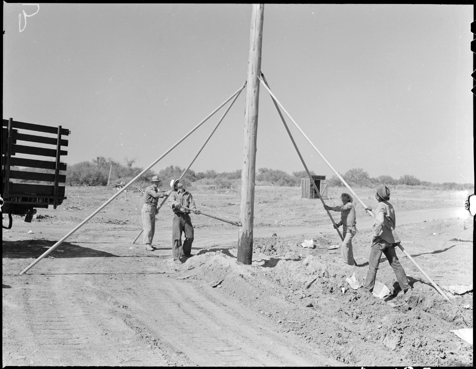 Poston, Arizona. High tension poles being installed at this War Relocation Authority center for eva . . . - NARA - 536151