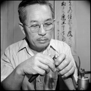 Poston, Arizona. Mr. Niseki shows how to make beautiful rings out of the stones which may be picked . . . - NARA - 539882