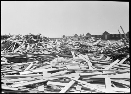 Poston, Arizona. Scrap lumber which will be put to many uses by evacuees of Japanese ancestry upon . . . - NARA - 536324 photo