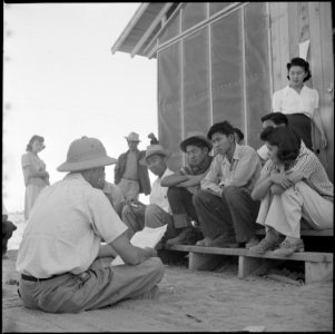 Poston, Arizona. Norris James, War Relocation Authority representative gives instructions and assig . . . - NARA - 538570