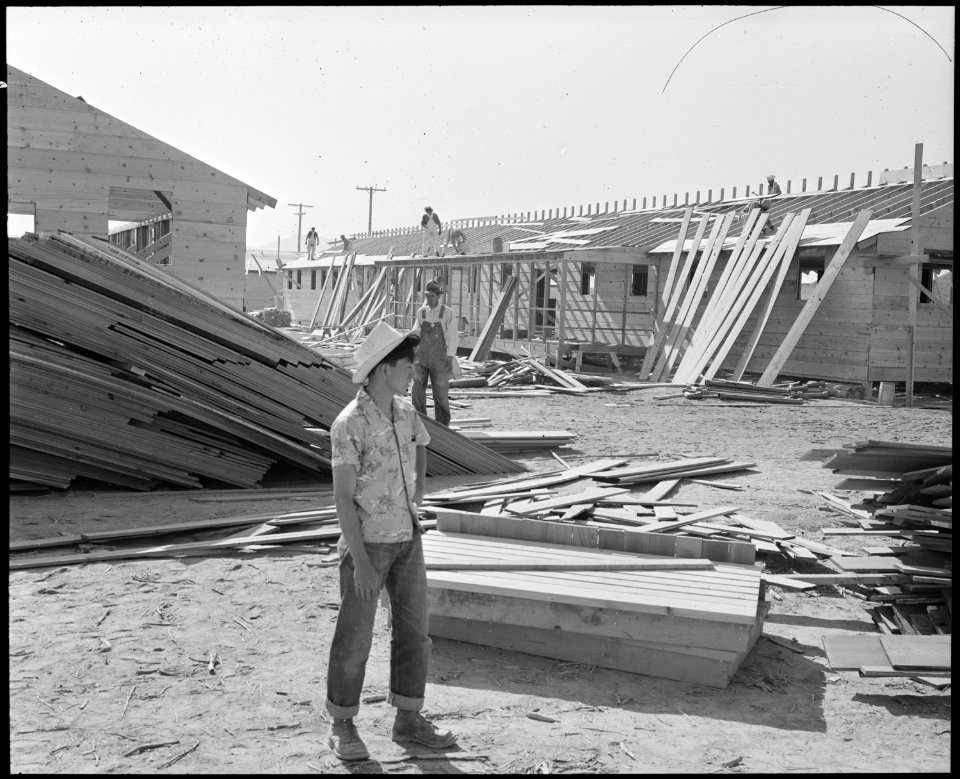 Poston, Arizona. Site Number 1. Larry Orida watches erection of the hospital at this War Relocatio . . . - NARA - 536075