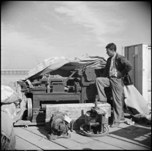 Poston, Arizona. Norris James with a Whitlook flat-bed printing press, which is owned by the staff . . . - NARA - 536611 photo