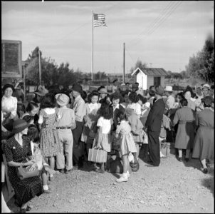 Poston, Arizona. Evacuees stand in line before the departure station where they are to receive thei . . . - NARA - 539869 photo