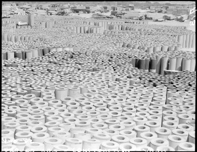Poston, Arizona. Rolls of roofing used in the construction of the War Relocation Authority center l . . . - NARA - 536009