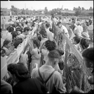 Poston, Arizona. The bus waits outside and young and old are anxious to be off. After the final pl . . . - NARA - 539871