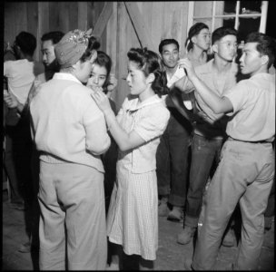 Poston, Arizona. Yachiyo Honda and Sakae Nakasaki pin a favor on Jean Honda at a barn dance given b . . . - NARA - 538577