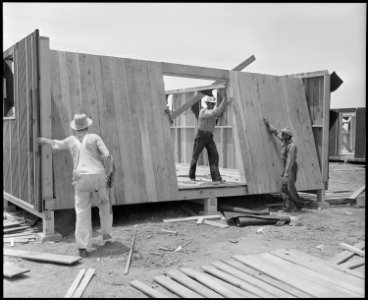 Poston, Arizona. Showing construction of living quarters for evacuees of Japanese ancestry at this . . . - NARA - 536301 photo