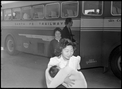 Poston, Arizona. Young mother of Japanese ancestry arrives with her young baby at this War Relocati . . . - NARA - 536323 photo