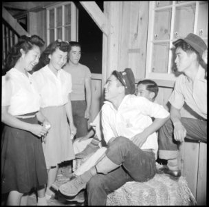 Poston, Arizona. Two young girl evacuees of Japanese ancestry invite their boy friends to dance at . . . - NARA - 538576