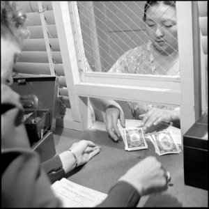 Poston, Arizona. Yoshiko Matsushigo receives her cash grant of $25 before she leaves Poston for her . . . - NARA - 539877