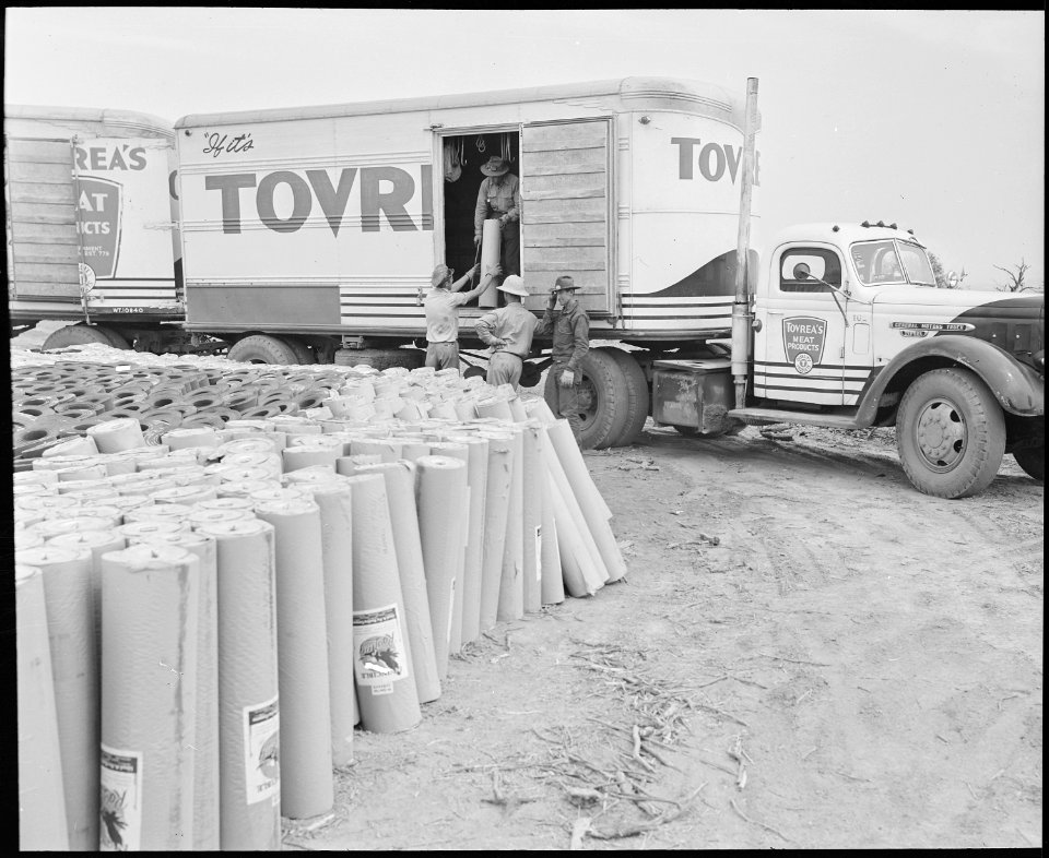 Poston, Arizona. Unloading roofing paper to be used in the construction of barracks at the Colorado . . . - NARA - 536320