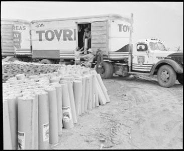 Poston, Arizona. Unloading roofing paper to be used in the construction of barracks at the Colorado . . . - NARA - 536320