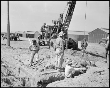 Poston, Arizona. Installing fire hydrants at this War Relocation Authority center for evacuees of J . . . - NARA - 536312 photo