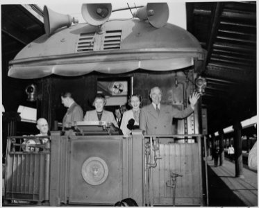 President and Mrs. Harry S. Truman, Margaret Truman, and two unidentified men stand on the rear platform of the... - NARA - 199966