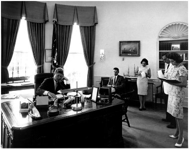 President addresses AMVETS Convention in New York City by telephone. President Kennedy, assistants. White House, Oval... - NARA - 194181