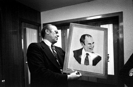 President Ford examines a wood portrait - NARA - 7160309