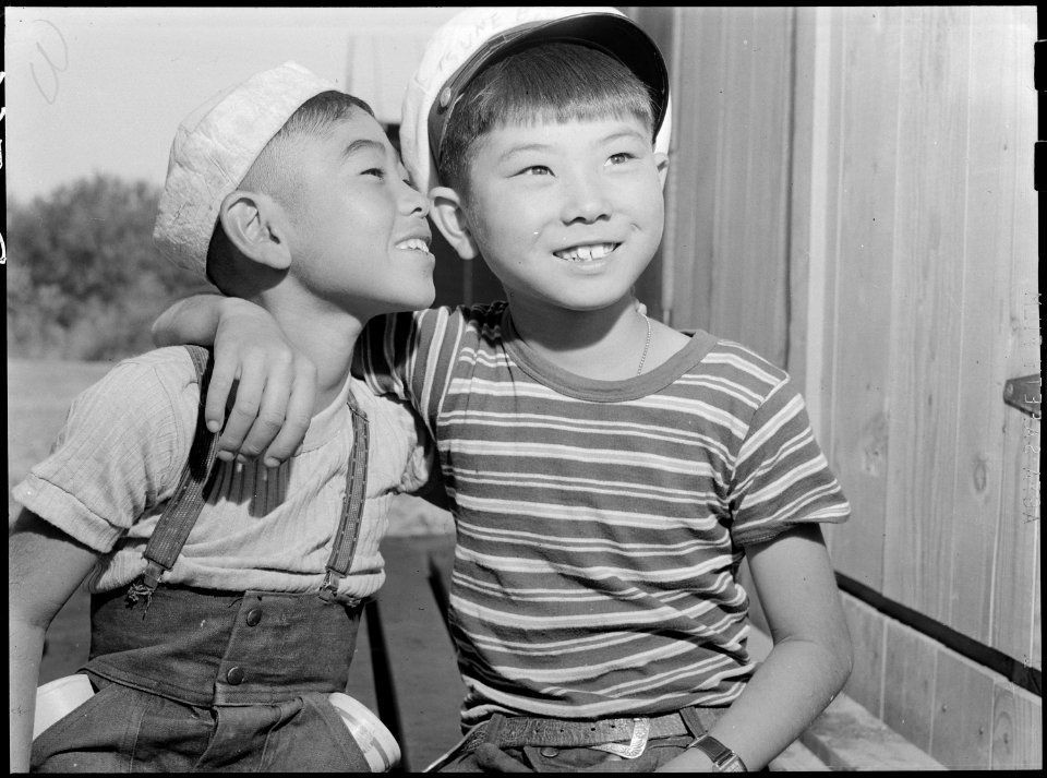 Poston, Arizona. These two little evacuees of Japanese ancestry are getting acquainted at this War . . . - NARA - 538531