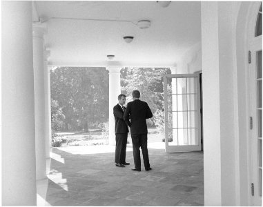 President confers with Attorney General. Attorney General Kennedy, President Kennedy. White House, West Wing Collonade. - NARA - 194239 photo