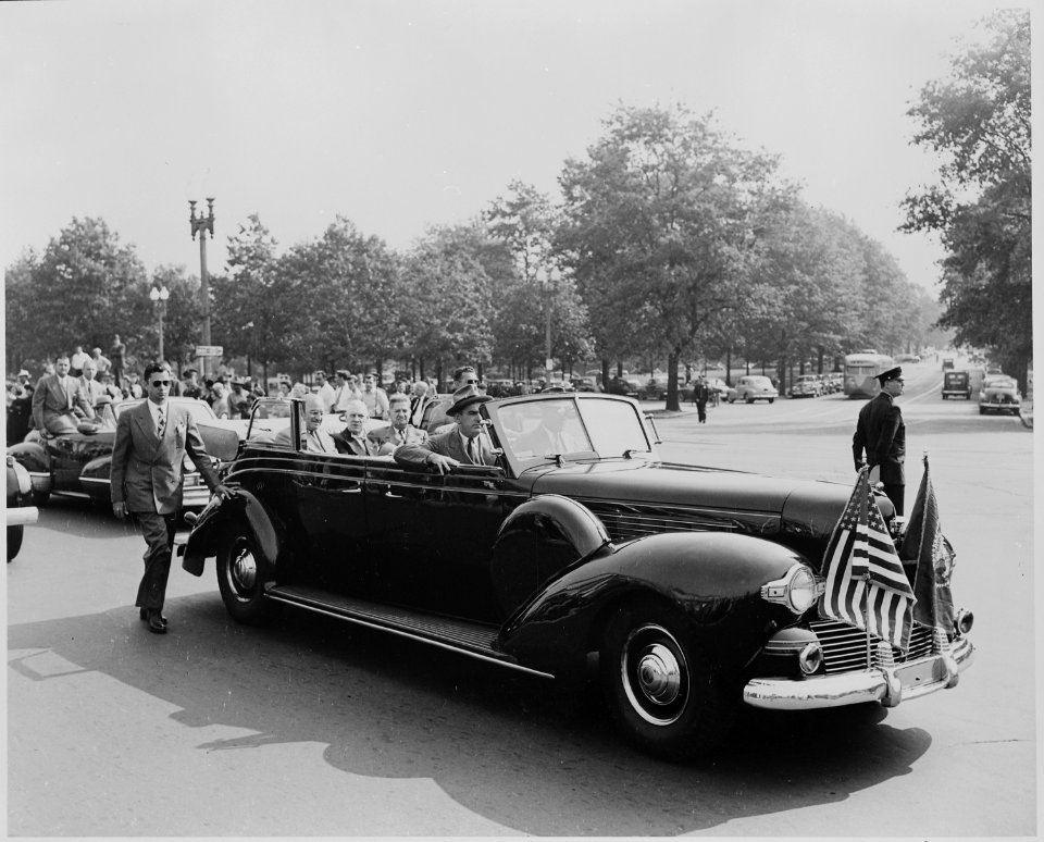 President Harry S. Truman sitting in an open car with four unidentified men, Washington, DC. President Truman had... - NARA - 199964
