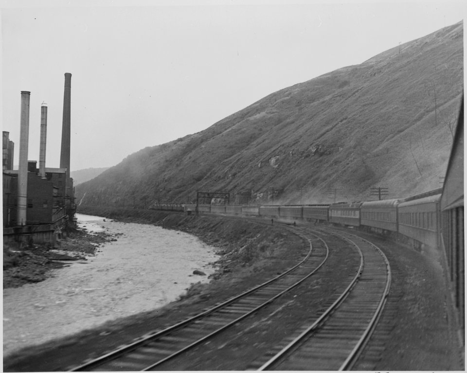 President Harry S. Truman' train, passing through the mountains, a factory on one side. President Truman was on a... - NARA - 199932