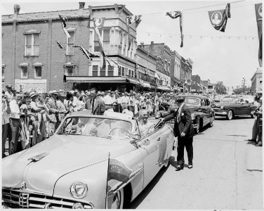 President Harry S. Truman and four other men riding in a convertible down a main street in Bolivar, Missouri. The... - NARA - 199911 photo