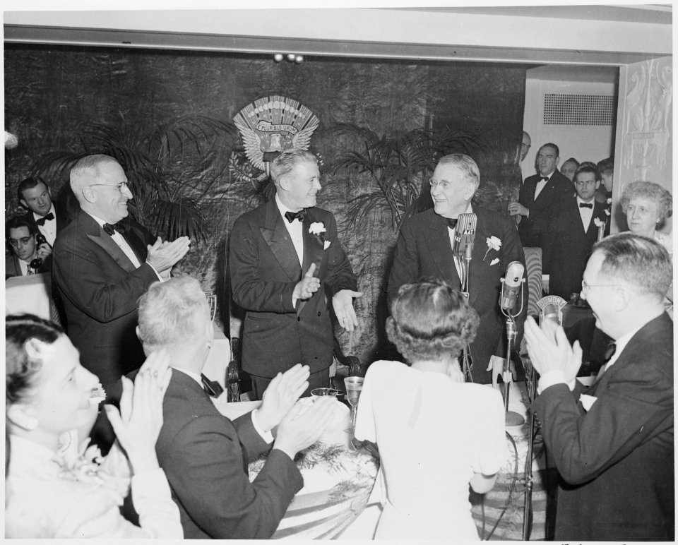 President Truman (at left) stands and applauds Vice President Alben Barkley (third from left) at the dinner honoring... - NARA - 200016