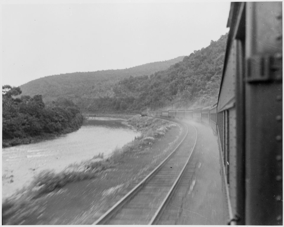 President Harry S. Truman's train, passing through the mountains, with a river alongside. President Truman was on a... - NARA - 199934