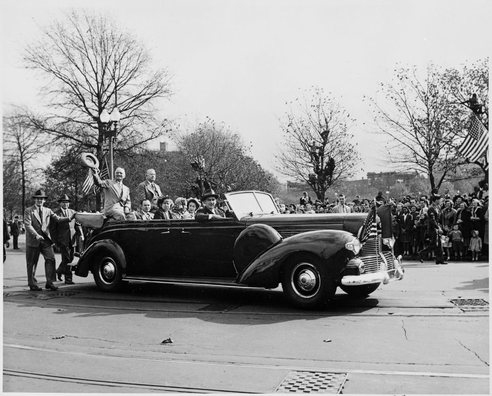 President Harry S. Truman and Vice President-elect Alben W. Barkley, riding on the back of an open car down a street... - NARA - 199938