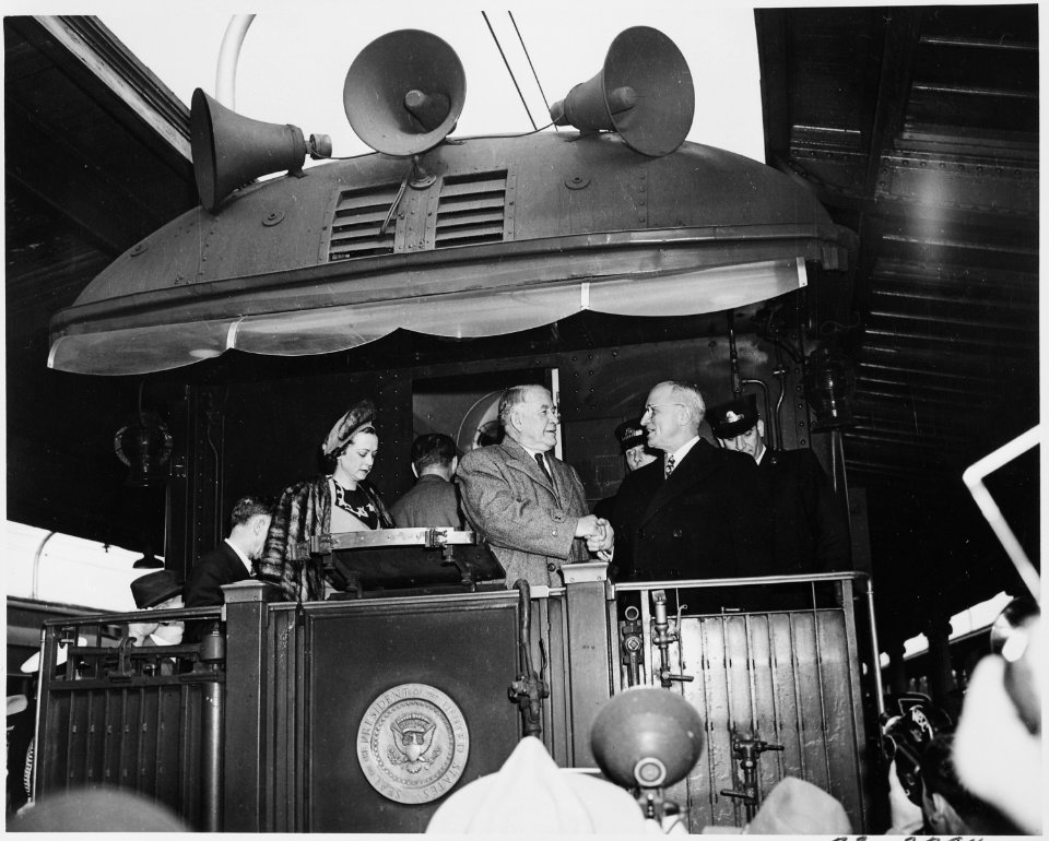 President Harry S. Truman shakes hands with Vice President-elect Alben W. Barkley on the rear platform of the... - NARA - 199942