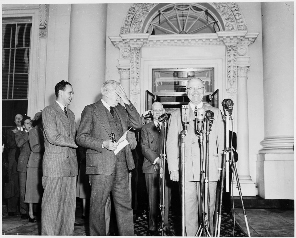 President Harry S. Truman, Vice President-elect Alben W. Barkley, and others standing on the front porch of the White... - NARA - 199948