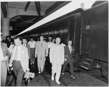 President Harry S. Truman walking in a station, beside the presidential train. President Truman was on a trip to... - NARA - 199929