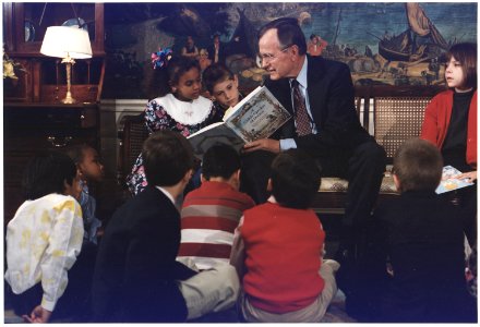 President Bush reads a book to children during Great American Read Aloud Day in the Diplomatic Reception Room - NARA - 186432